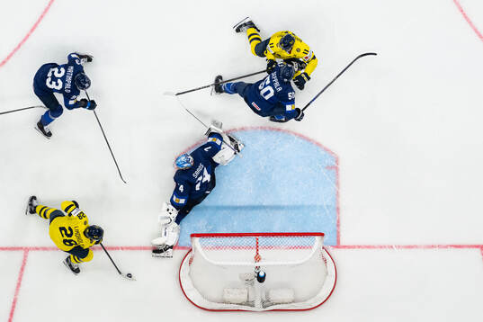 Elias Lindholm and Mikael Backlund of Sweden against