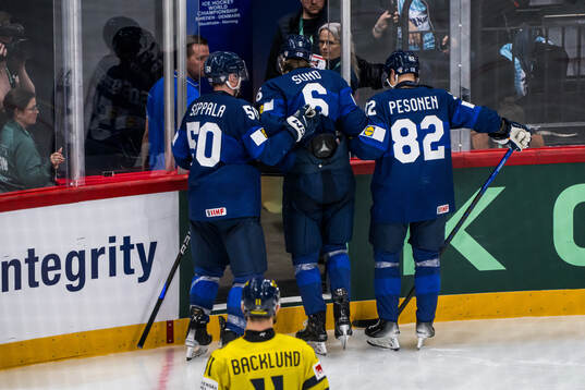 Mikael Seppälä and Harri Pesonen help Tony Sund of