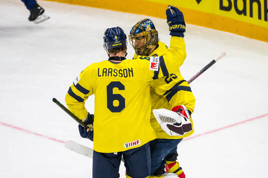Adam Larsson and goaltender Jacob Markström of Sweden