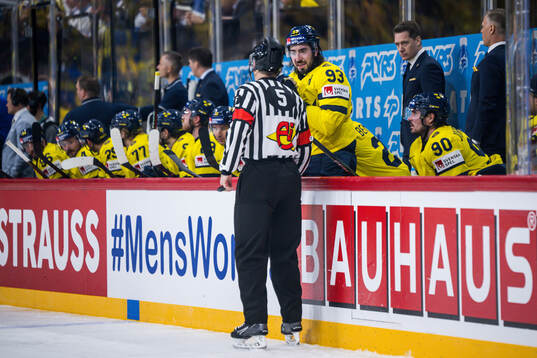 Mika Zibanejad of Sweden in a discussion with referee Andre
