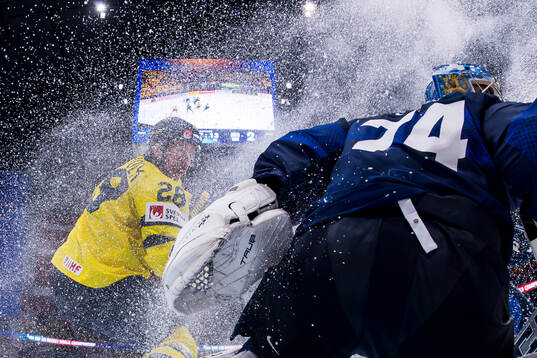 Elias Lindholm of Sweden and goalkeeper Juuse Saros of