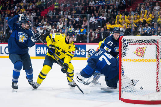 Mikael Backlund of Sweden against goaltender Juuse Saros