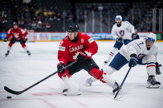 Nathan MacKinnon of Canada and Pierre Crinon of France