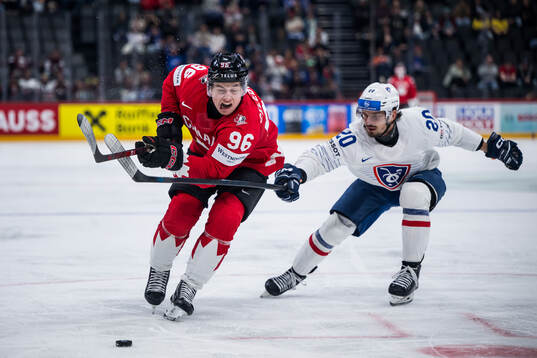Macklin Celebrini of Canada and Fabien Colotti of France