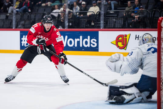 Kent Johnson of Canada and goaltender Julian Junca of France