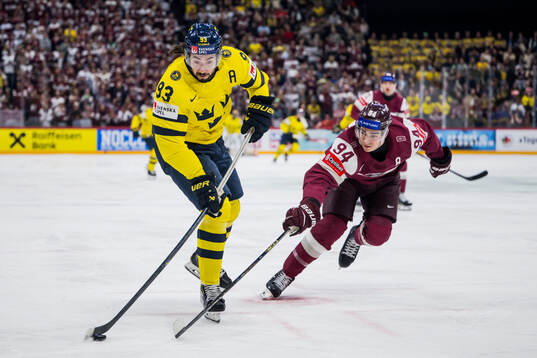 Mika Zibanejad of Sweden and Kristians Rubins of Latvia