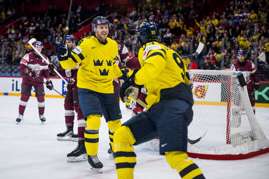 Jonas Brodin and Mika Zibanejad of Sweden celebrating the