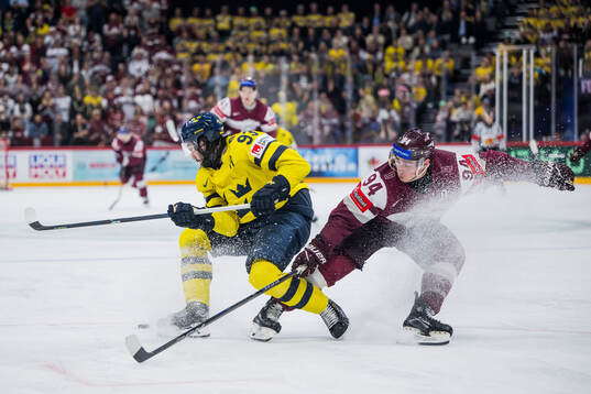 Mika Zibanejad of Sweden and Kristians Rubins of Latvia