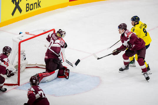 Toms Andersons and goalkeeper Kristers Gudlevskis of Latvia