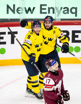 Jonas Brodin and Mika Zibanejad of Sweden celebrate
