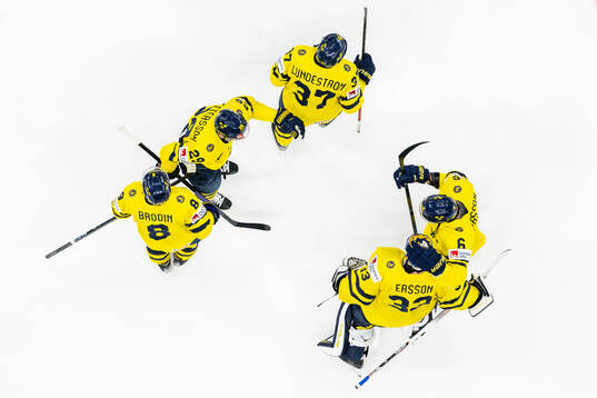 Goaltender Samuel Ersson of Sweden celebrates with teammates
