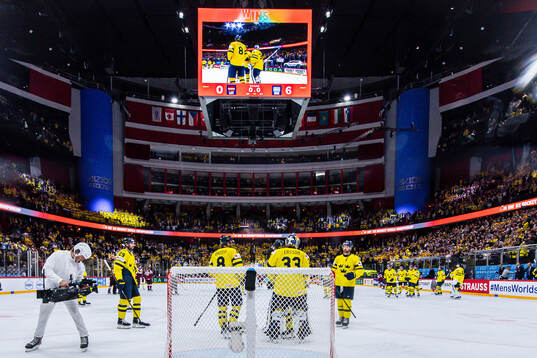 Goaltender Samuel Ersson of Sweden celebrates with teammates
