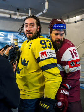 Mika Zibanejad of Sweden and Kaspars Daugavins of Latvia