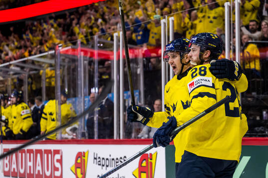 Mikael Backlund and Elias Lindholm celebrate