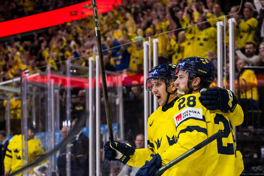 Mikael Backlund and Elias Lindholm celebrate