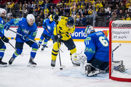 Mikael Backlund of Sweden and goaltender Lukas Horak of