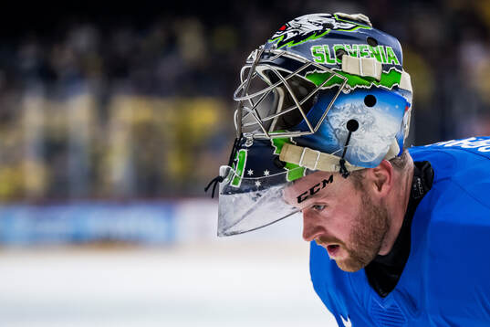 Goaltender Lukas Horak of Slovenia looks dejected