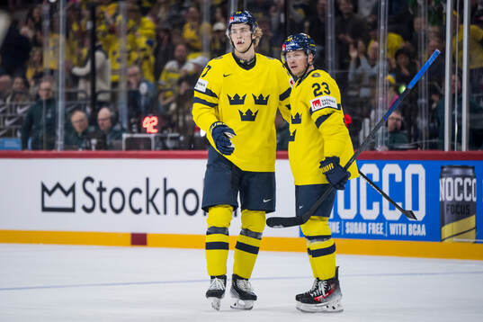 Simon Edvinsson and Lucas Raymond of Sweden celebrate