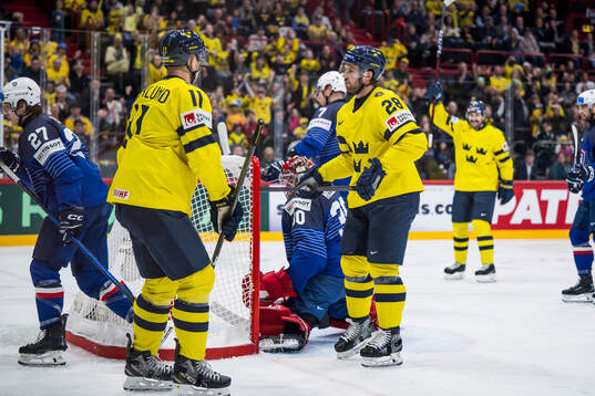 Mikael Backlund and Elias Lindholm of Sweden celebrate