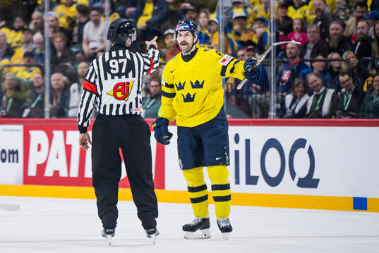 Referee Jan Hribik and Filip Forsberg of Sweden