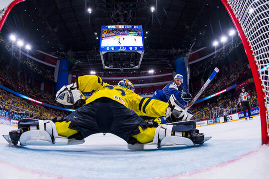 goaltender Samuel Ersson of Sweden and Baptiste Bruche of