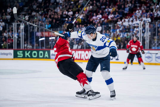 Macklin Celebrini of Canada and Eeli Tolvanen of Finland