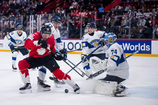 Macklin Celebrini of Canada and goaltender Juuse Saros of