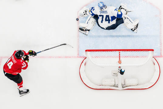 Bo Horvat of Canada and goaltender Juuse Saros of Finland