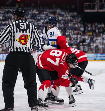 Juho Lammikko of Finland and Sidney Crosby of Canada