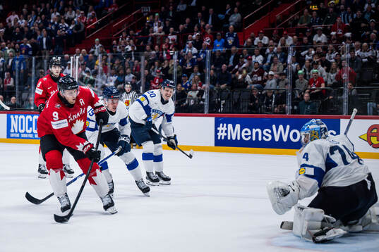 Nathan MacKinnon of Canada and Goalkeeper Juuse Saros of