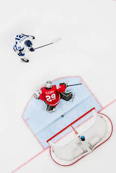 Patrik Puistola of Finland scores a goal behind goalkeeper