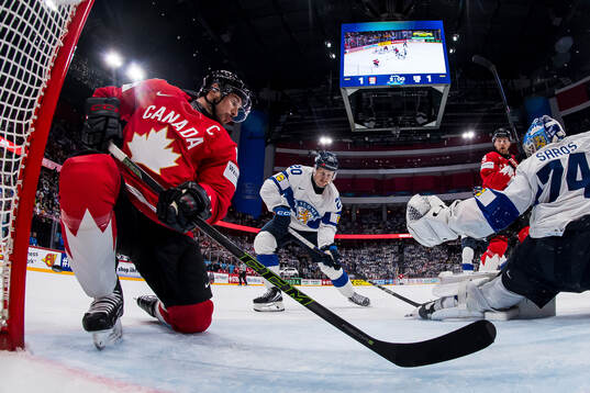Sidney Crosby and Nathan MacKinnon of Canada against Eeli
