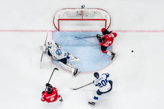 Sidney Crosby and Nathan MacKinnon of Canada against Eeli