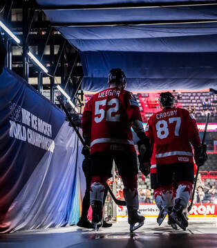 MacKenzie Weegar and Sidney Crosby of Canada