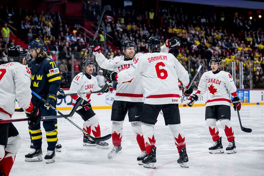 Nathan MacKinnon and Travis Sanheim of Canada celebrate