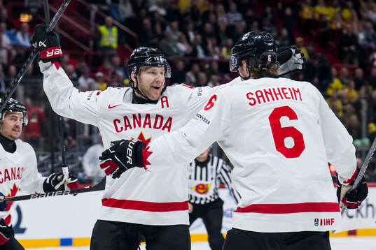 Nathan MacKinnon and Travis Sanheim of Canada celebrate