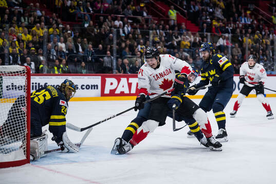 Tyson Foerster of Canada scores 1-2 behind goaltender Jacob