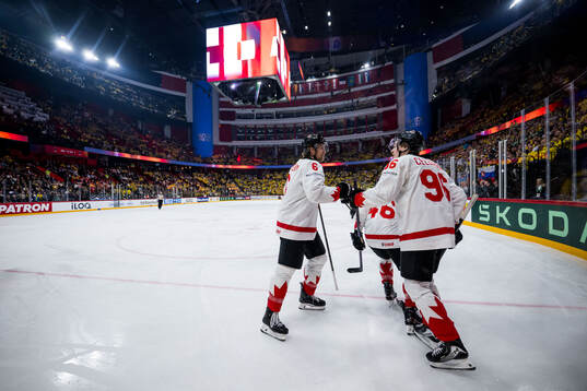 Travis Sanheim and Macklin Celebrini of Canada celebrate