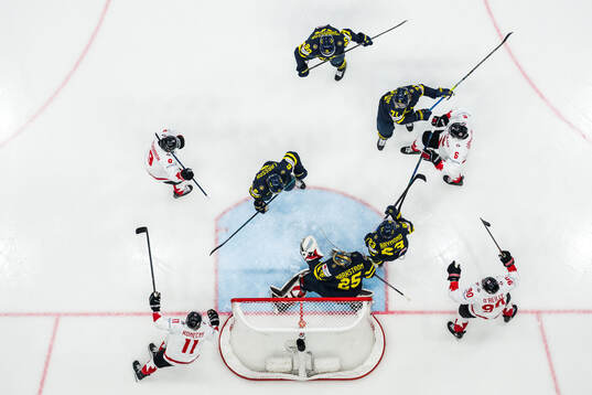 Travis Sanheim of Canada celebrates with Travis Konecny,