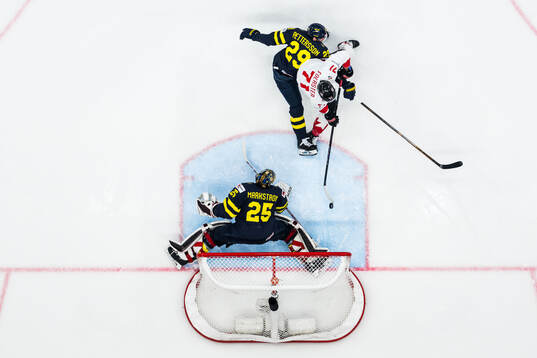 Tyson Foerster of Canada scores 1-2 behind goaltender Jacob