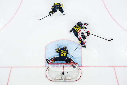 Tyson Foerster of Canada scores 1-2 behind goaltender Jacob