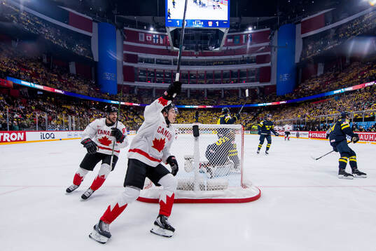 Sidney Crosby and Macklin Celebrini of Canada celebrate