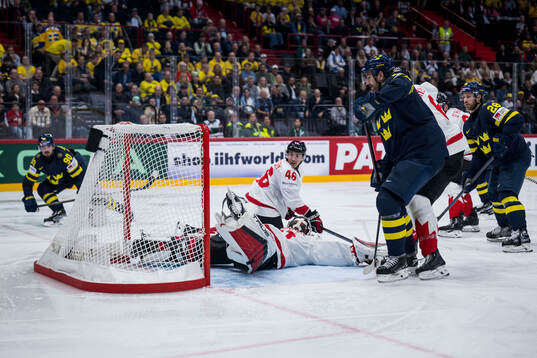 Marcus Johansson of Sweden scores 2-3 behind goaltender
