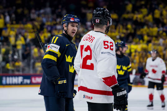Mikael Backlund of Sweden and MacKenzie Weegar of Canada