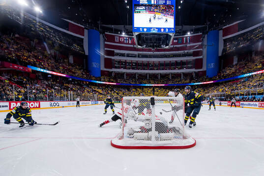 Marcus Johansson of Sweden scores 2-3 behind goaltender