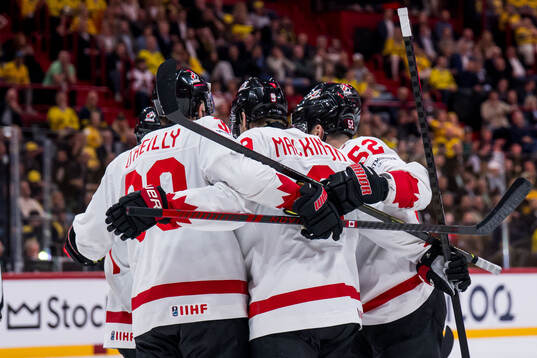 Nathan MacKinnon of Canada celebrates with teammates