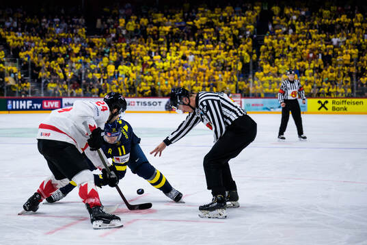 Phillip Danault of Canada and Mikael Backlund of Sweden
