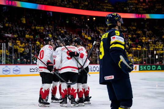 Nathan MacKinnon of Canada celebrates with teammates