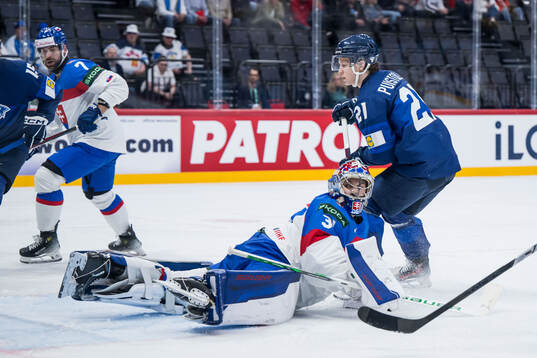 Patrik Puistola of Finland scores 0-1 behind goaltender