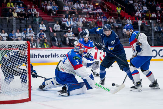 Juho Lammikko of Finland and goaltender Samuel Hlavaj of